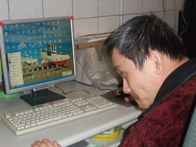 夥伴在電腦前操作資訊設備的歷史紀錄照片